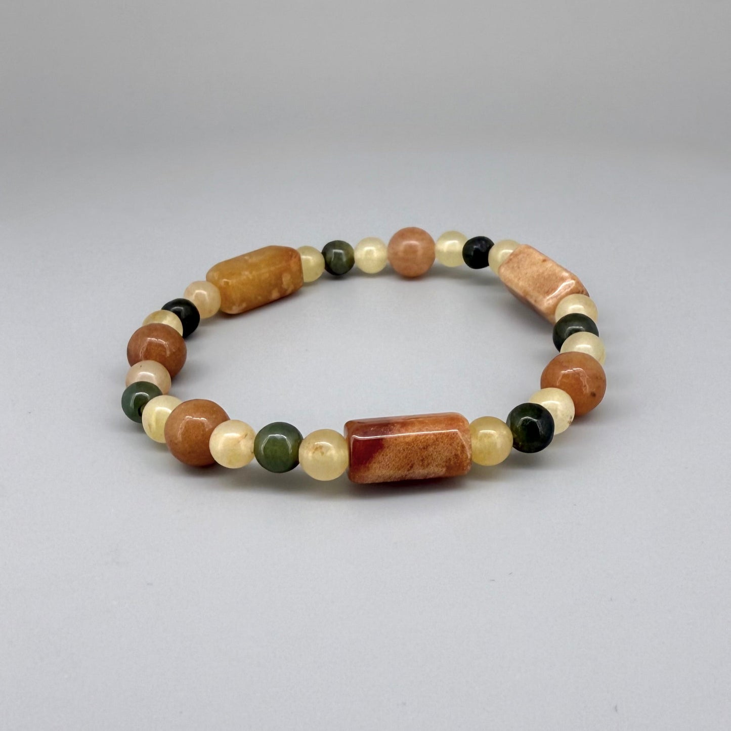 Jade beaded bracelet, 19cm, orange square stones with round beads in orange, green, and beige tones on elastic stretch band.