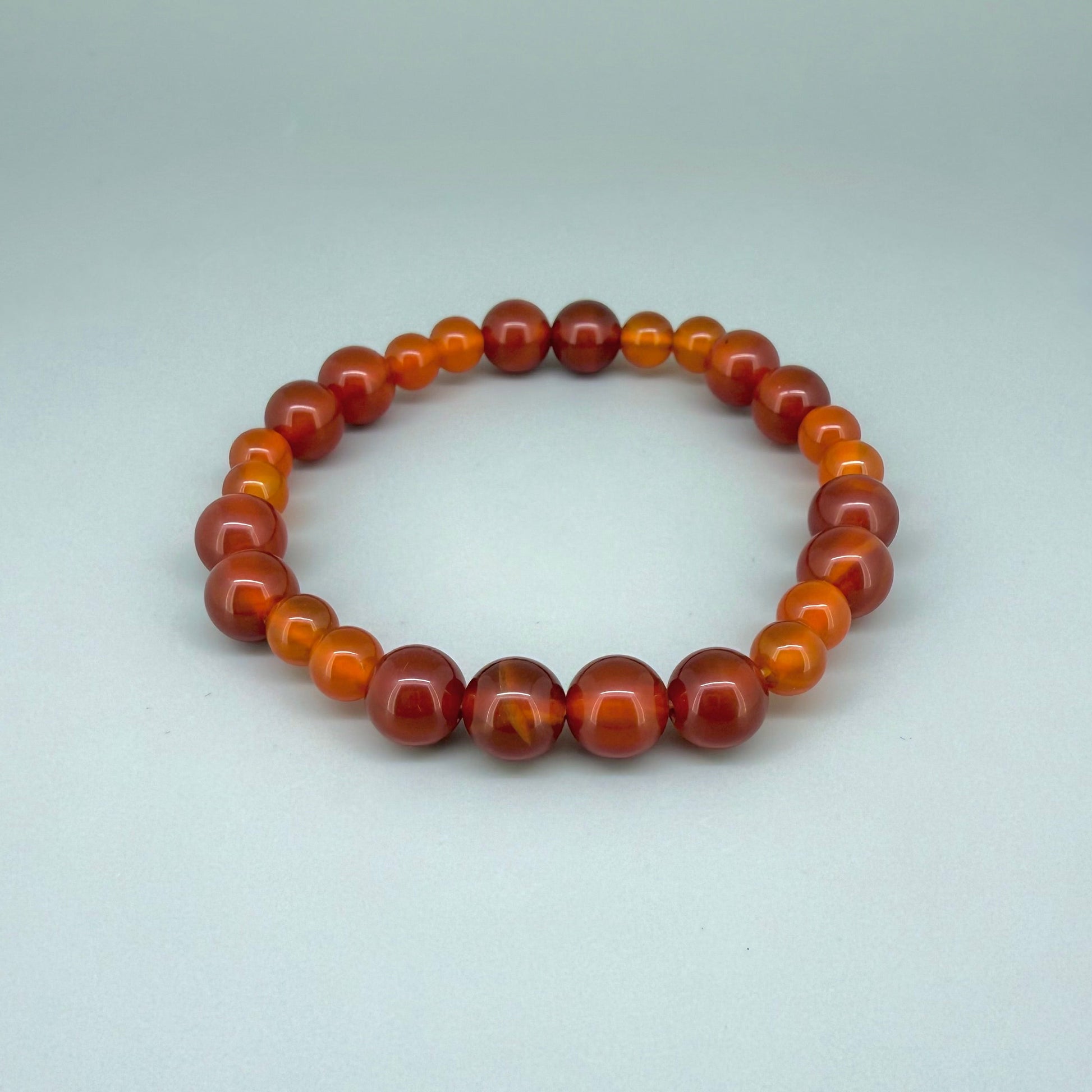 Carnelian beaded bracelet, 18cm, natural orange-red gemstone beads on elastic stretch band.