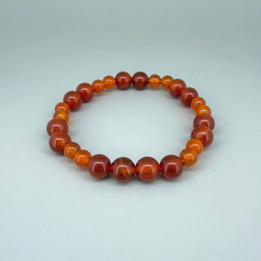 Carnelian beaded bracelet, 18cm, natural orange-red gemstone beads on elastic stretch band.