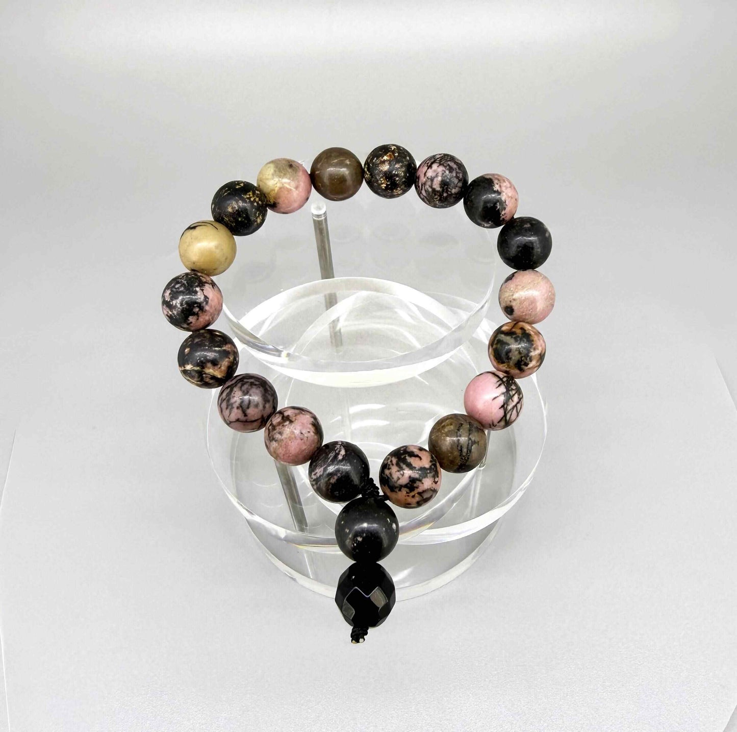 Rhodonite mala bracelet made from natural rhodonite beads, symbolizing emotional healing, compassion, and balance.