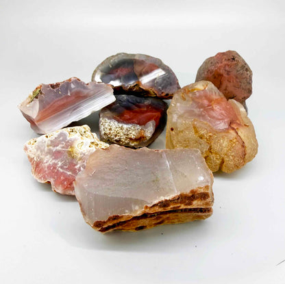 Mixed chalcedony rough stones with pink, orange-red and grey banded patterns, natural quartz lot.