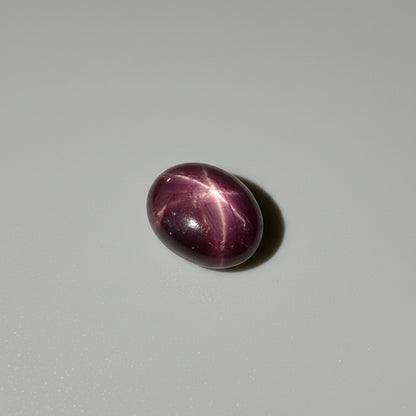 15.5 ct natural Bordeaux-Red Star Ruby cabochon from Mozambique with soft star effect and polished dome.