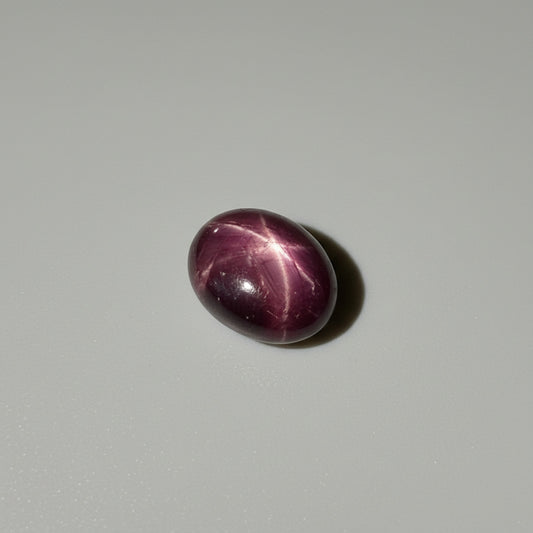 15.5 ct natural Bordeaux-Red Star Ruby cabochon from Mozambique with soft star effect and polished dome.