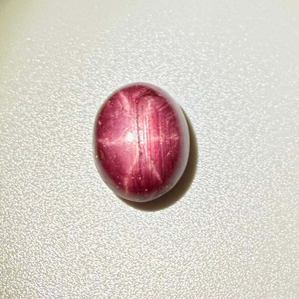 16.7 ct natural Bordeaux-Red Star Ruby cabochon from Mozambique with soft star effect and polished dome.