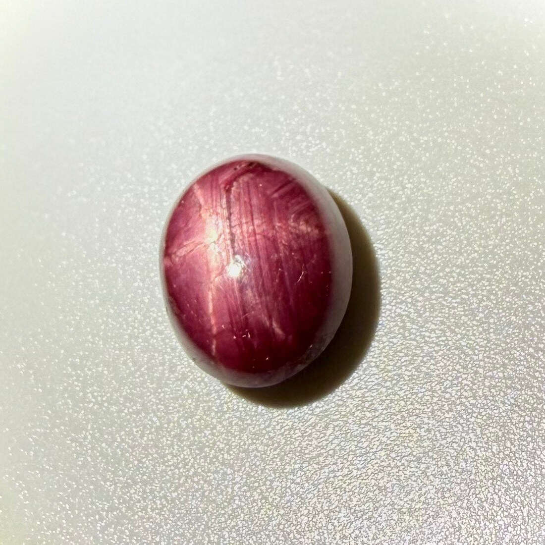 16.7 ct natural Bordeaux-Red Star Ruby cabochon from Mozambique with soft star effect and polished dome.