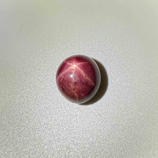 20.1 ct natural Pink-Red Star Ruby cabochon from Mozambique with soft star effect and polished dome.