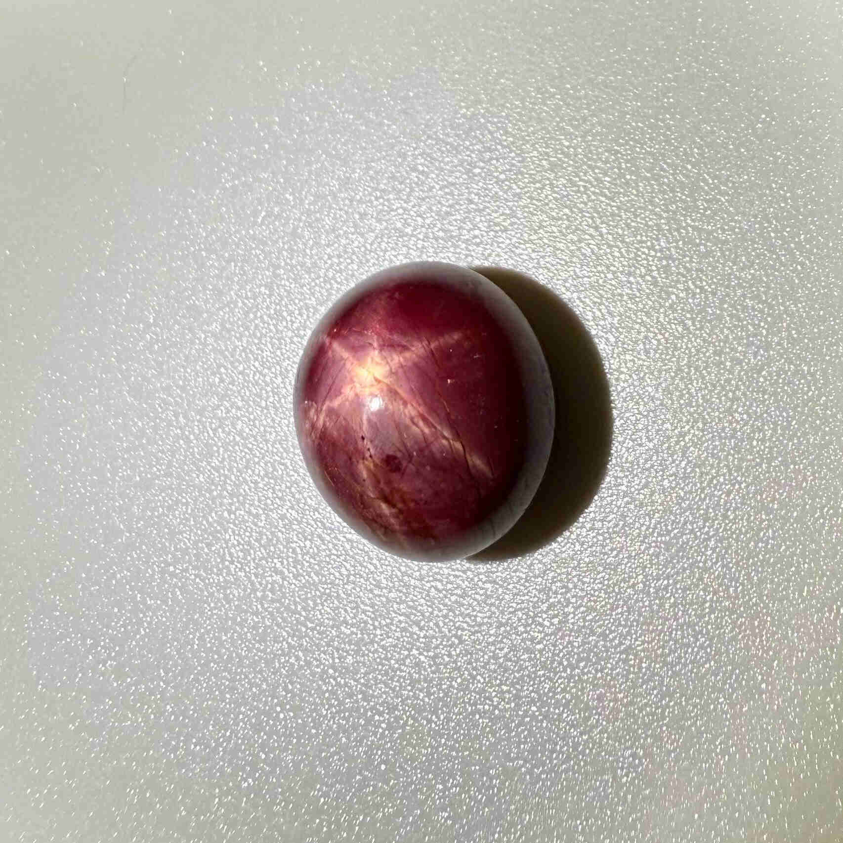20.1 ct natural Pink-Red Star Ruby cabochon from Mozambique with soft star effect and polished dome.