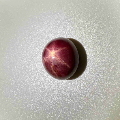20.1 ct natural Pink-Red Star Ruby cabochon from Mozambique with soft star effect and polished dome.