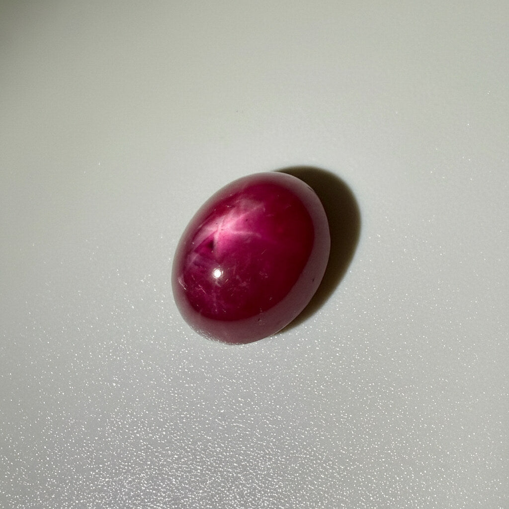 12.9 ct natural Star Ruby cabochon in deep pink-red with subtle star effect, polished dome and Mozambique origin.