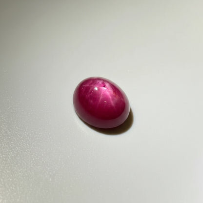 12.9 ct natural Star Ruby cabochon in deep pink-red with subtle star effect, polished dome and Mozambique origin.