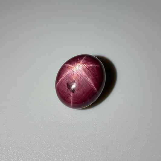 23.7 ct natural Bordeaux-Red Star Ruby cabochon from Mozambique with a clearly defined star and polished dome.