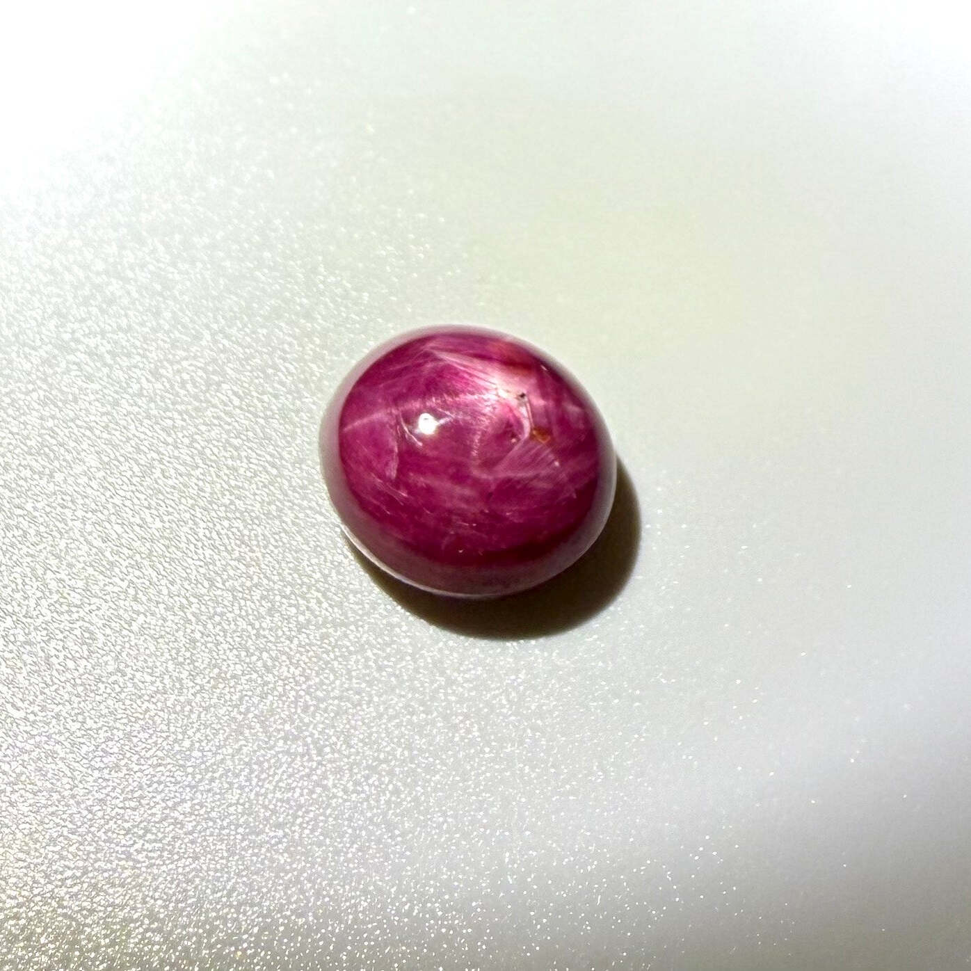 19.1 ct natural Star Ruby cabochon with visible star effect, deep red color and polished dome shape