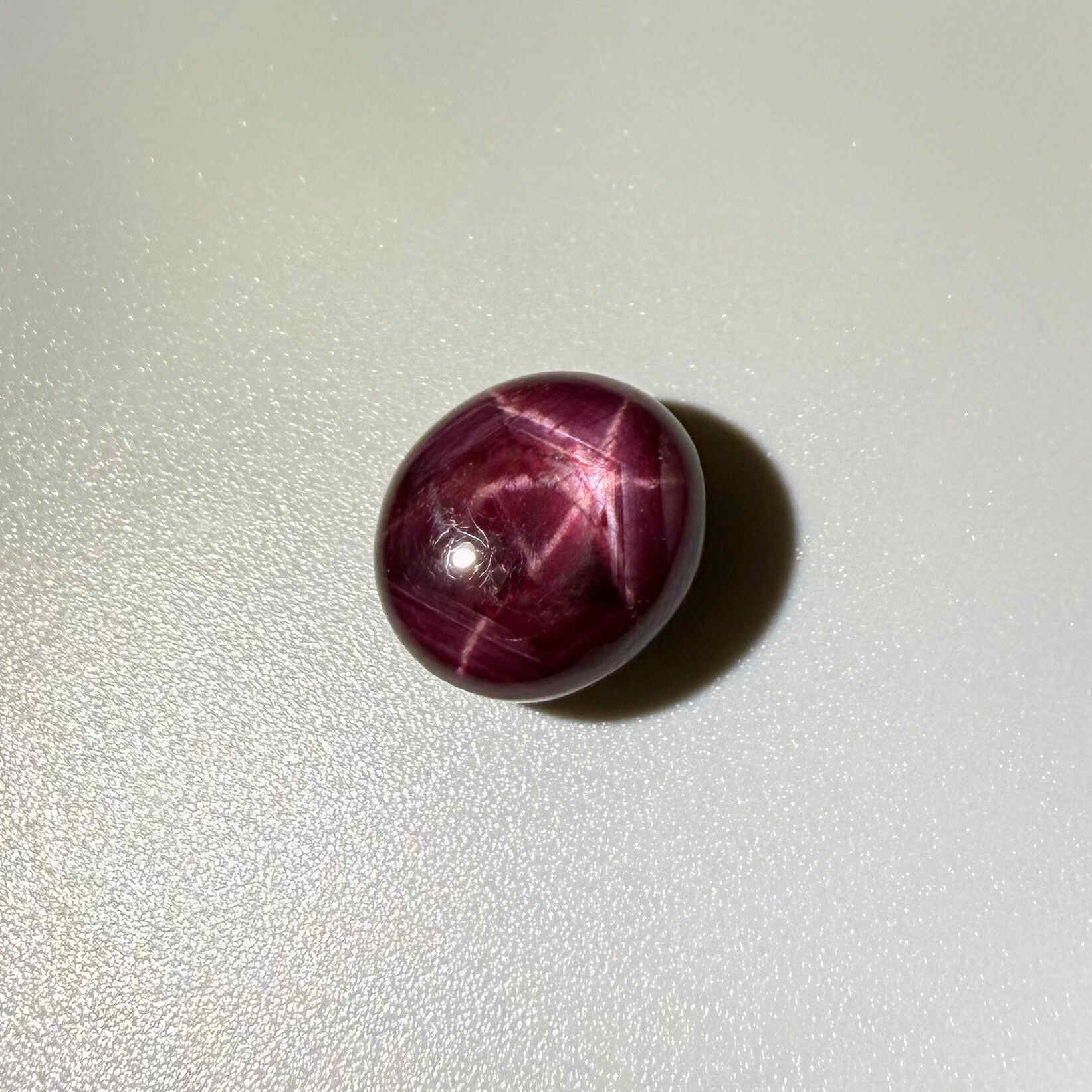 17.3 ct natural Pink-Red Star Ruby cabochon from Mozambique with soft star effect and polished dome.