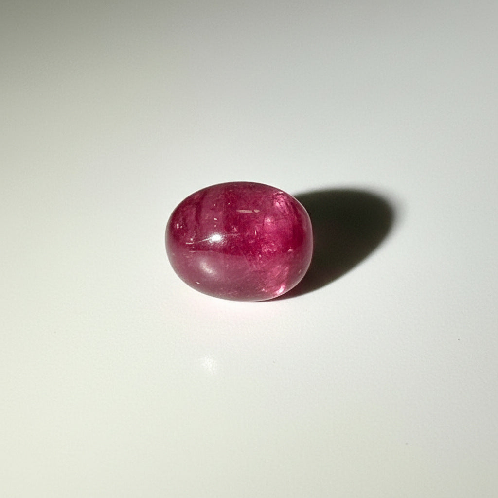 14.4 ct natural Pink-Red Star Ruby cabochon from Mozambique with soft star effect and polished dome.
