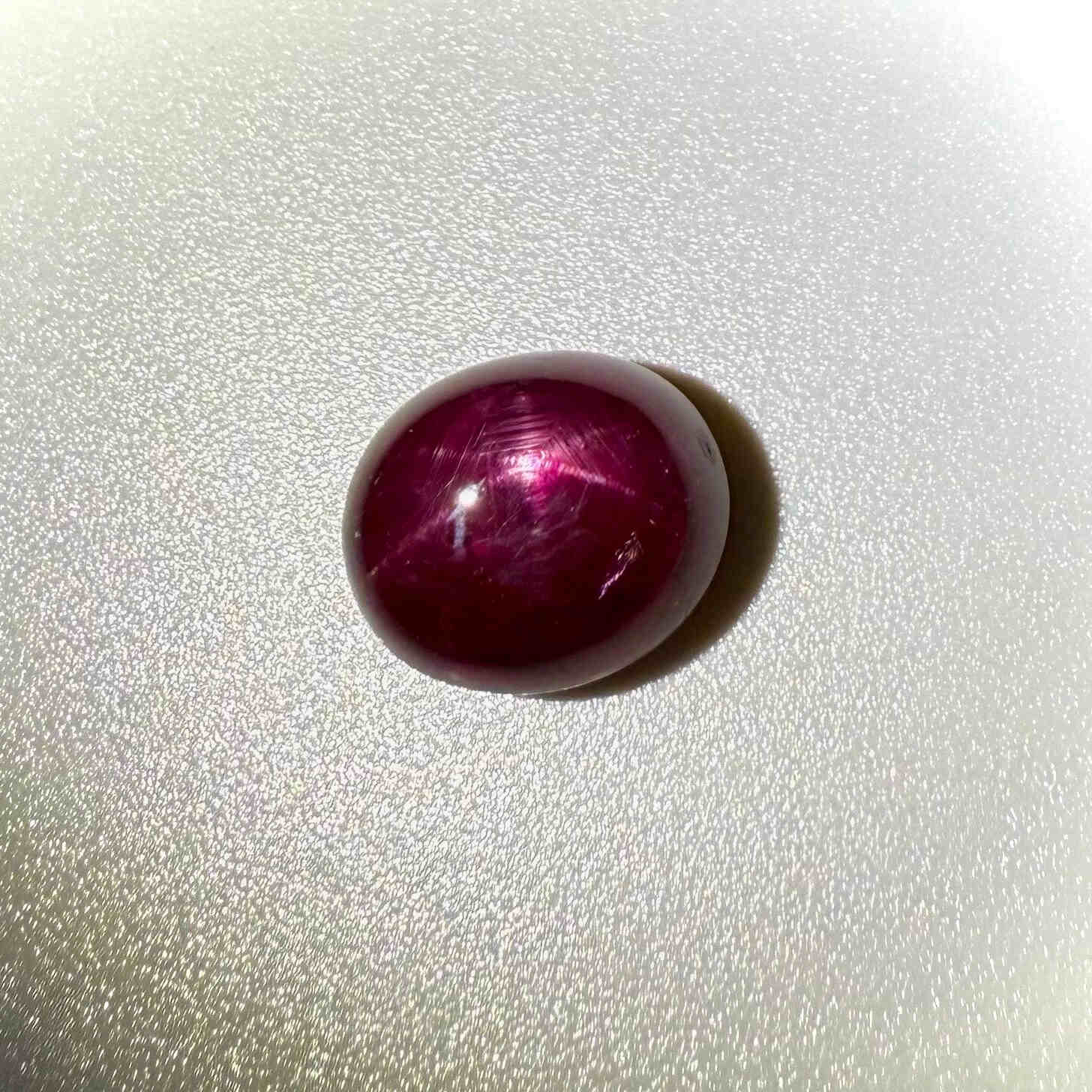13.5 ct natural Pink-Red Star Ruby cabochon from Mozambique with soft star effect and polished dome.