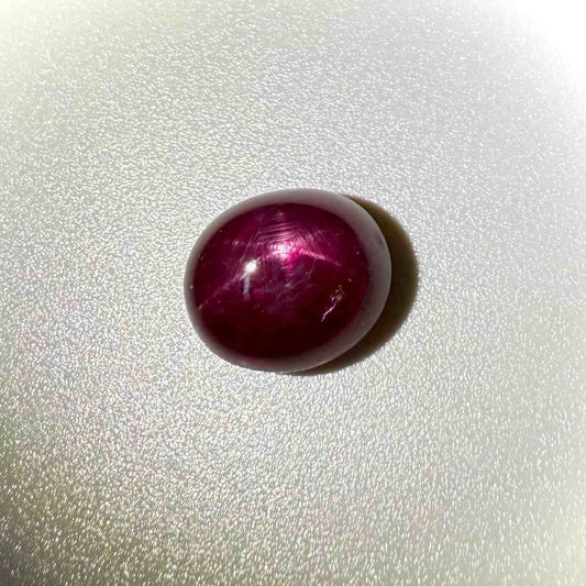 13.5 ct natural Pink-Red Star Ruby cabochon from Mozambique with soft star effect and polished dome.