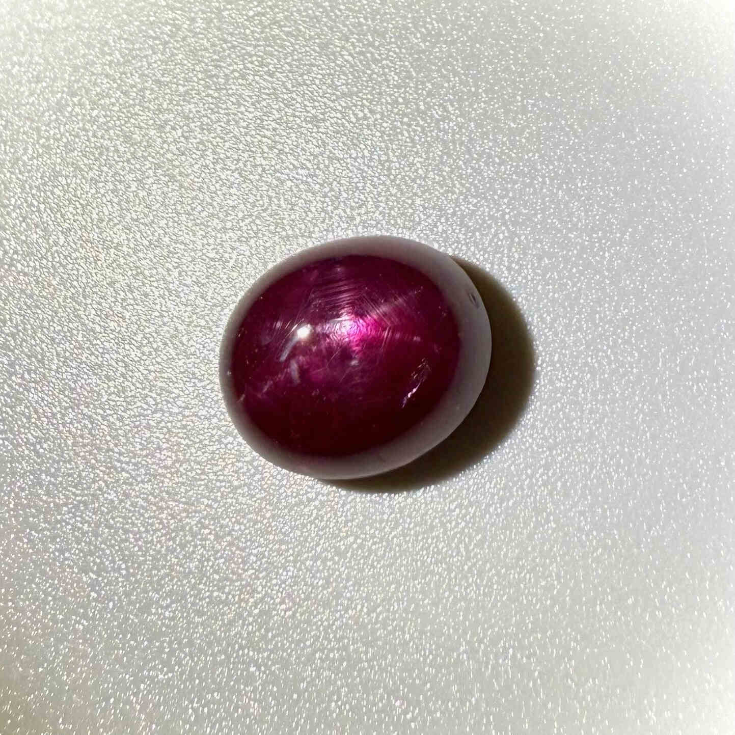 13.5 ct natural Pink-Red Star Ruby cabochon from Mozambique with soft star effect and polished dome.