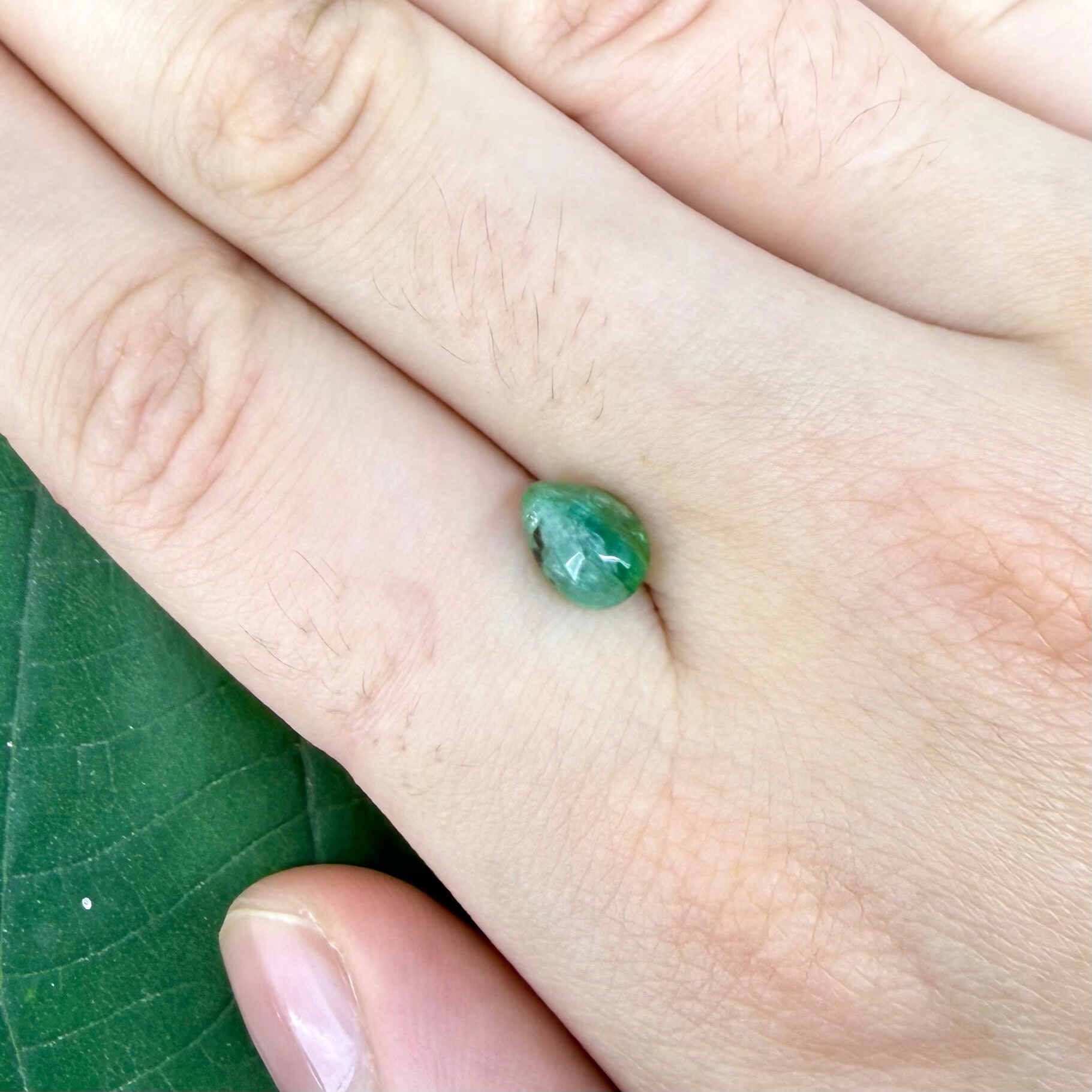1.42 ct natural untreated emerald from Zambia, one side polished and the other cabochon-shaped.