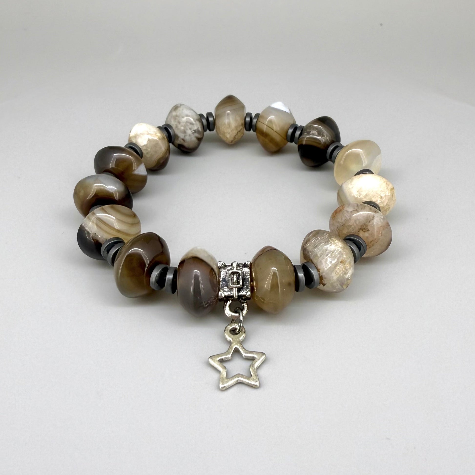 Agate and hematite beaded bracelet, 19cm, beige-brown gemstone beads with metallic hematite accents and silver star charm on elastic stretch band.