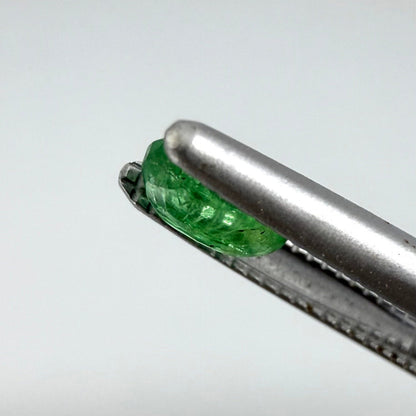 0.22 ct natural untreated Zambian emerald, oval faceted with vivid bluish-green color.