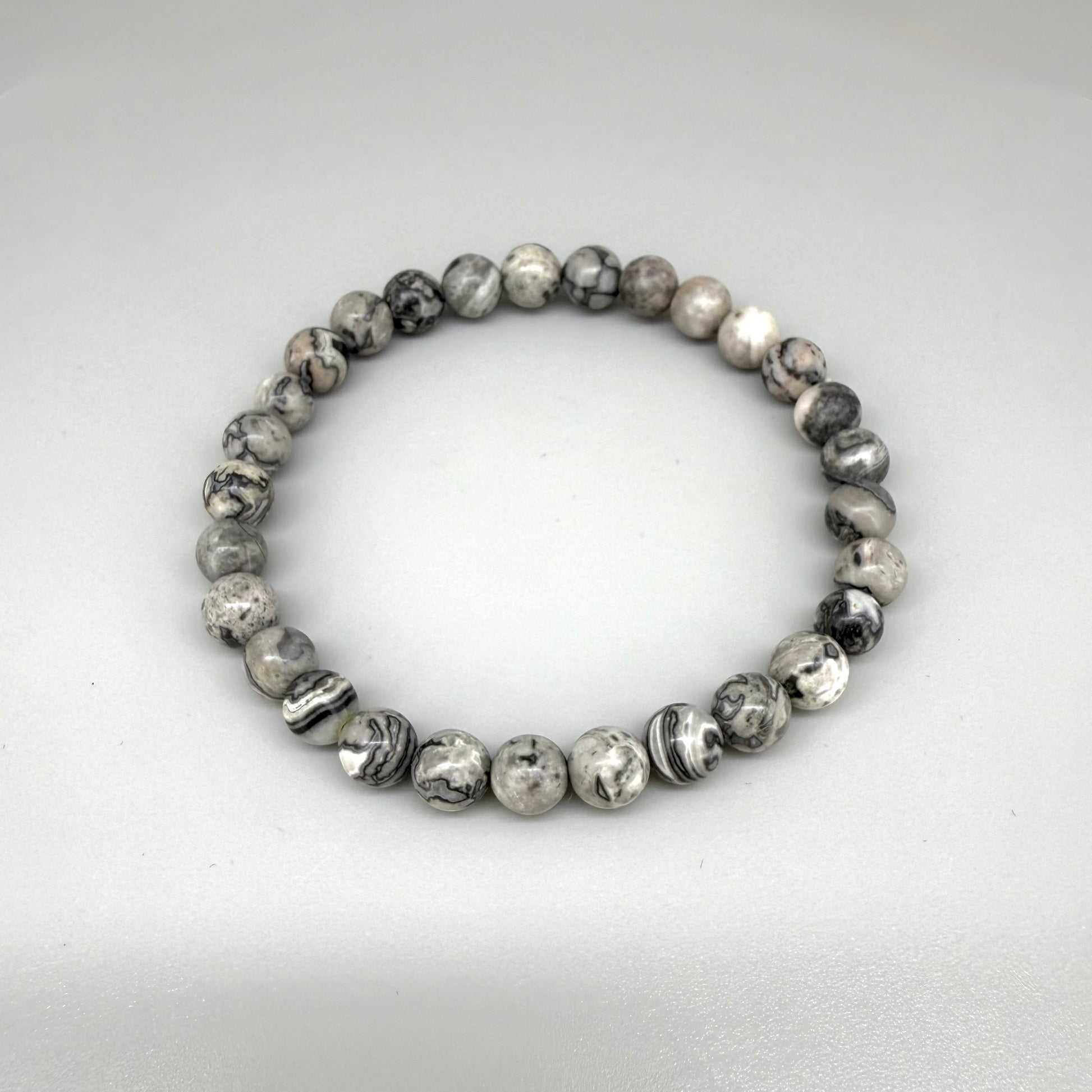 Jasper beaded bracelet, natural grey, black, and white marbled gemstone beads on elastic stretch band.