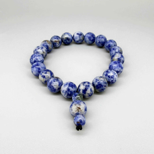 Blue Jasper mala bracelet with marbled blue and white natural gemstone beads and decorative charm detail.