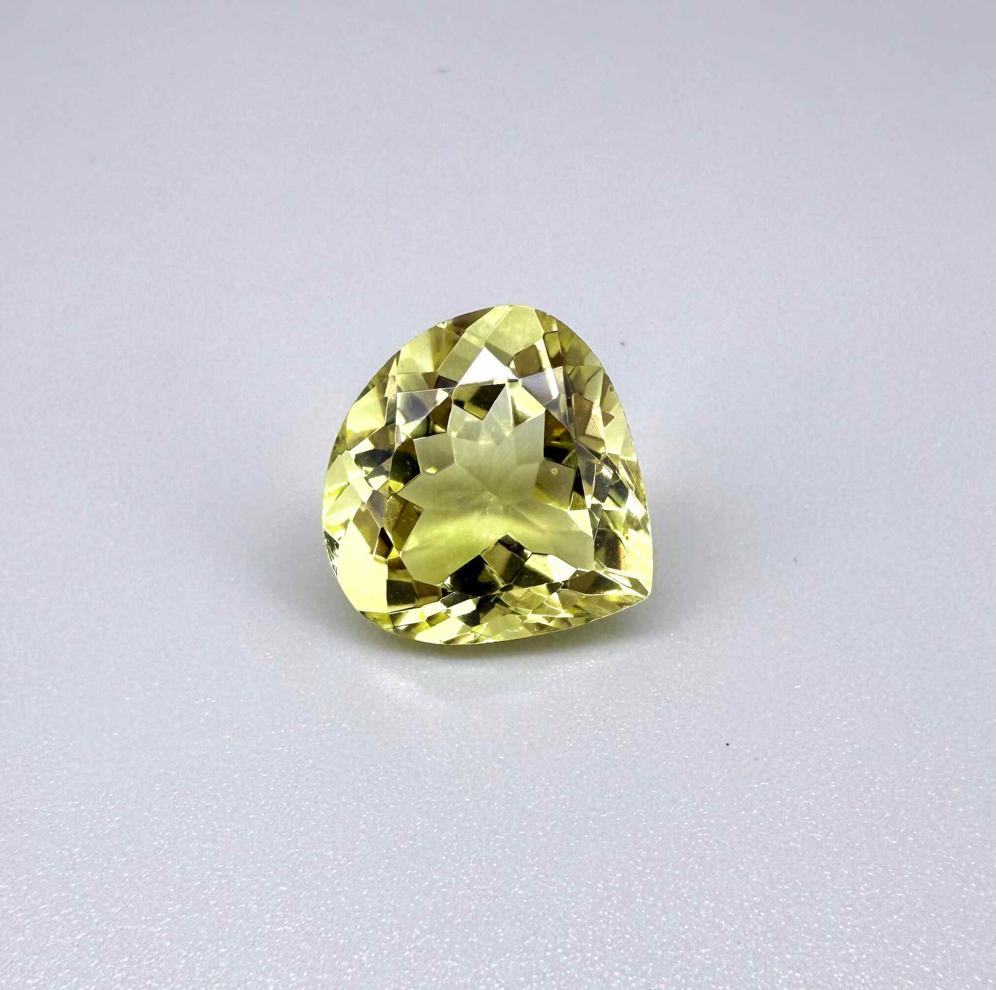 8 ct natural lemon quartz, trillion cut with bright yellow color.