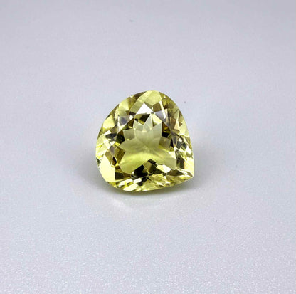 8 ct natural lemon quartz, trillion cut with bright yellow color.