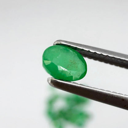 5.5 ct natural untreated Zambian emerald lot, faceted oval stones with vivid bluish-green color.