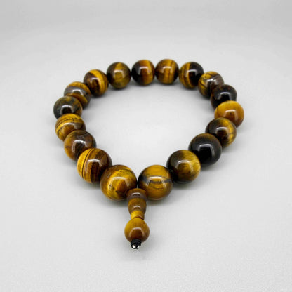 Tiger’s eye mala bracelet made from natural golden-brown tiger’s eye beads, symbolizing confidence, protection, and inner strength.