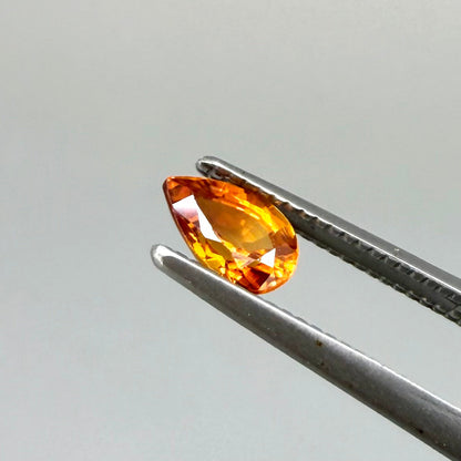 0.5 ct natural fiery-orange spessartine garnet from Namibia, pear cut.