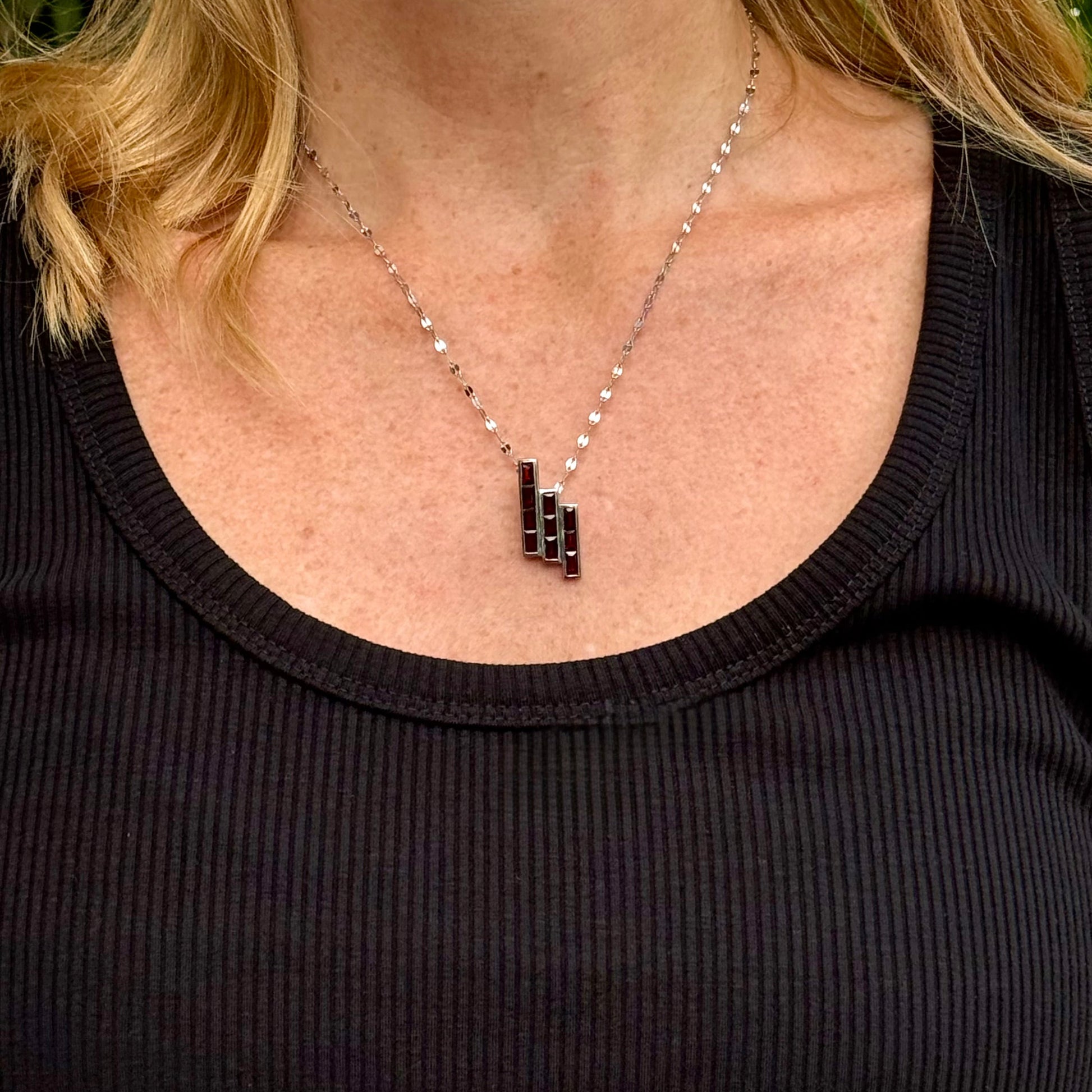 Handcrafted geometric pendant with 2.67 ct natural garnets set in sterling silver.