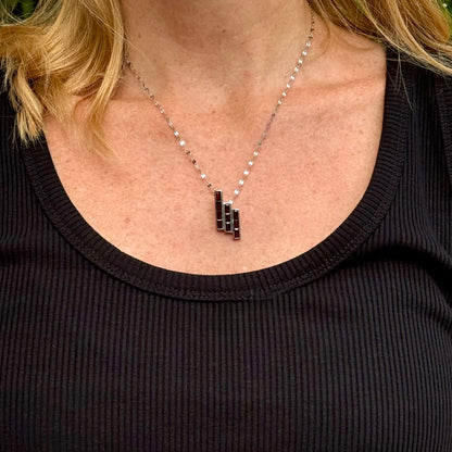 Handcrafted geometric pendant with 2.67 ct natural garnets set in sterling silver.