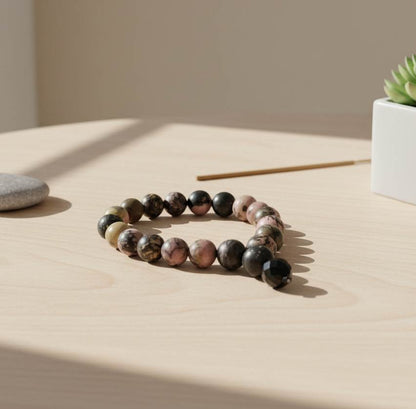 Rhodonite mala bracelet made from natural rhodonite beads, symbolizing emotional healing, compassion, and balance.