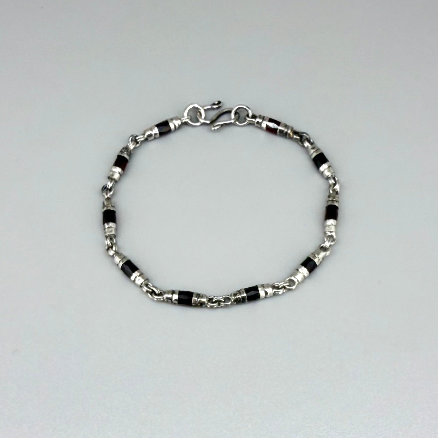 Garnet Pyrope bracelet styled on wrist with natural lighting, showcasing deep red hues
