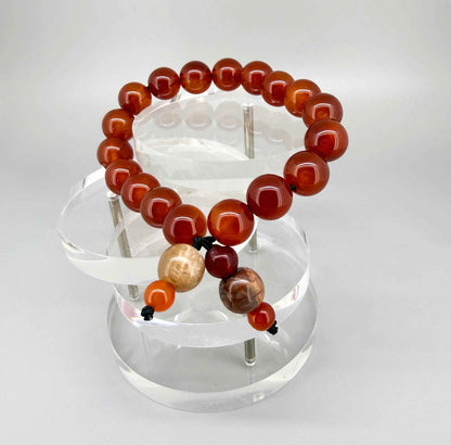 Carnelian mala bracelet made from natural warm orange-red carnelian beads, designed for grounding, vitality, and everyday wear.