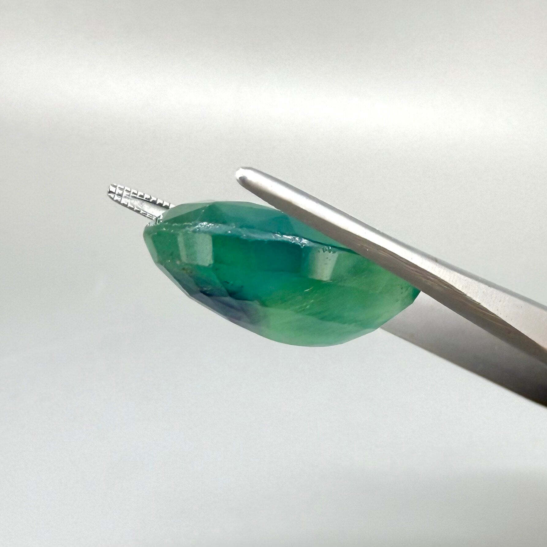33.9 ct natural green-blue Fluorite, oval faceted, eye-clear with slight dusty or milky appearance, from Africa.