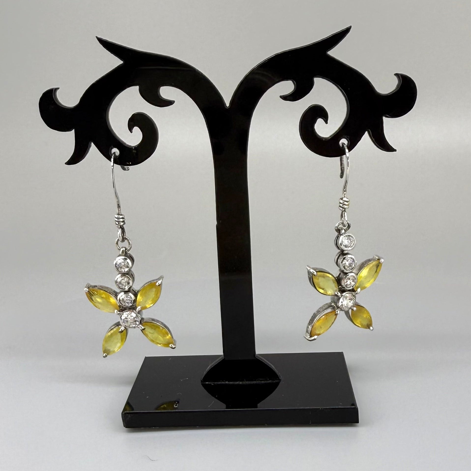 Sterling silver drop earrings with yellow sapphires and cubic zirconia in a floral design, linked to the Sapphire Jewelry Collection.