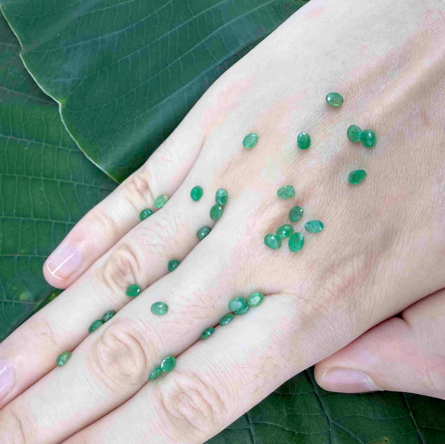 5.5 ct natural untreated Zambian emerald lot, faceted oval stones with vivid bluish-green color.