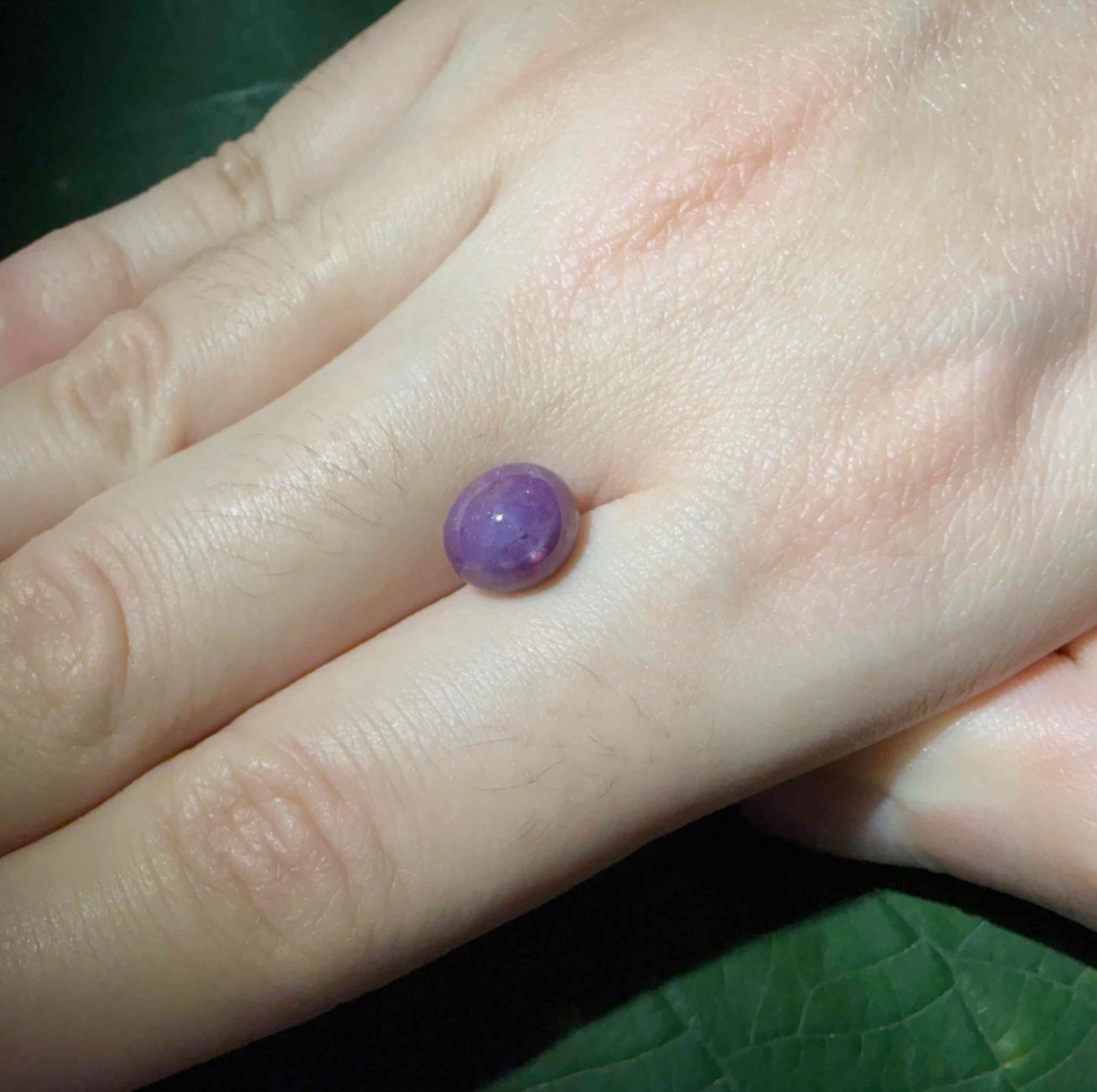 3.94 ct natural pink-purple Star Ruby cabochon from Madagascar with soft star effect and polished dome.