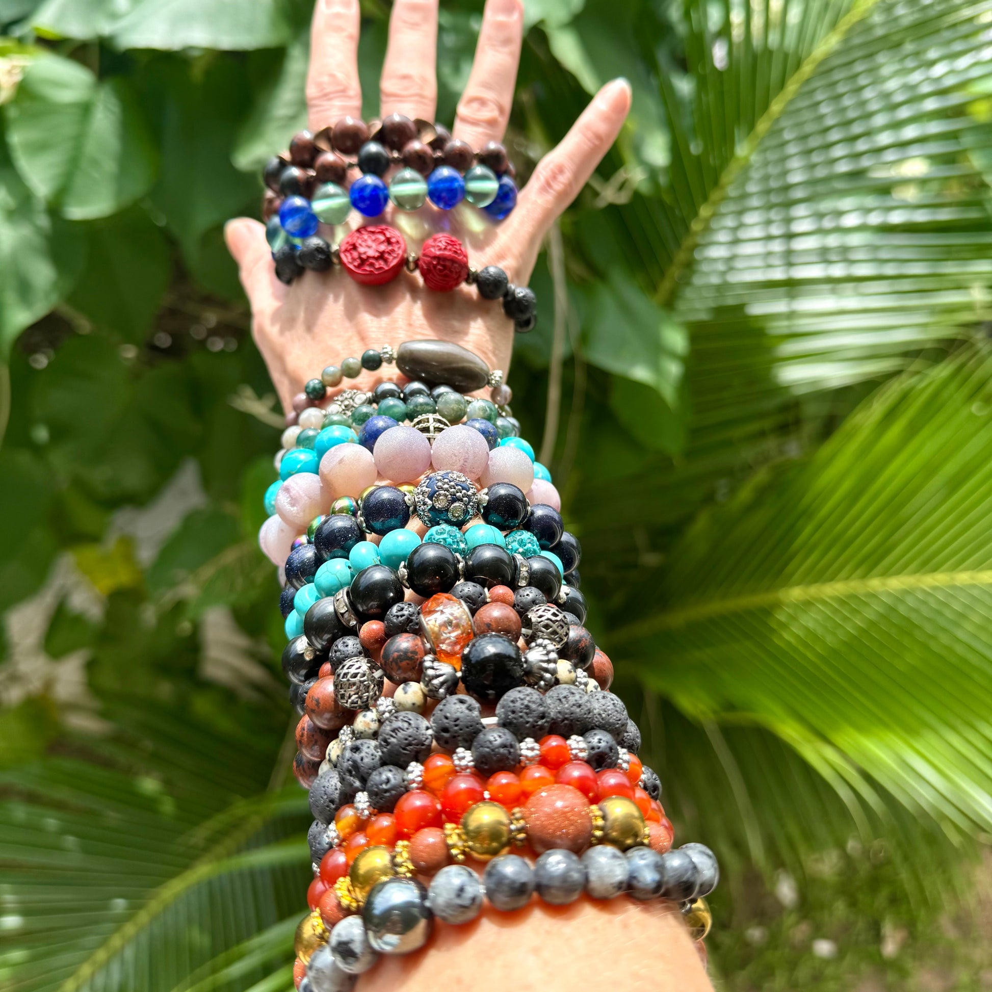 Multiple Natural Gemstone Bracelets worn on arm