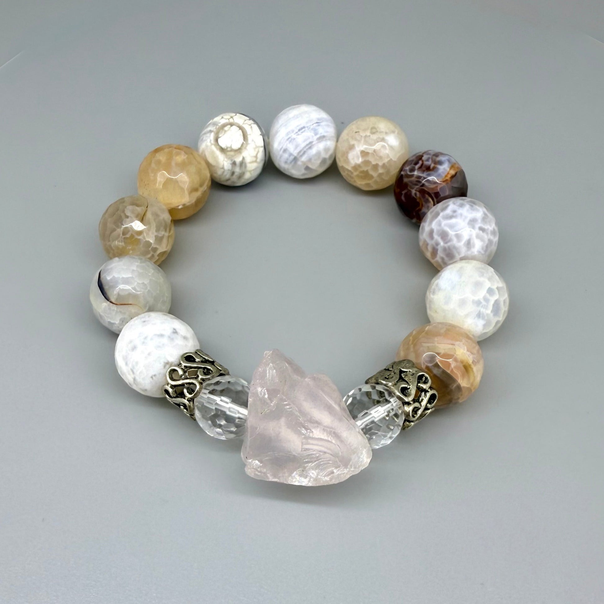 Dragon vein agate beaded bracelet, 18cm, beige-brown patterned gemstone beads with carved rose quartz focus stone and silver accents on elastic stretch band.