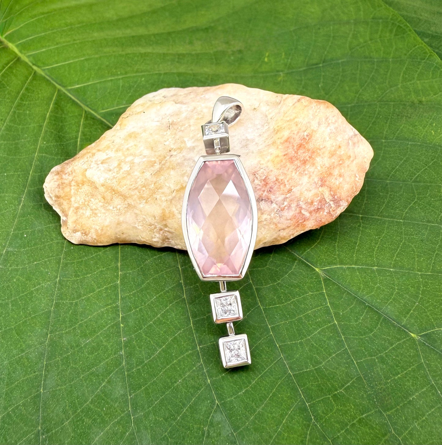 Handmade white gold plated silver pendant with 14.76 ct rose quartz and cubic zirconia accents, elegant and refined design.