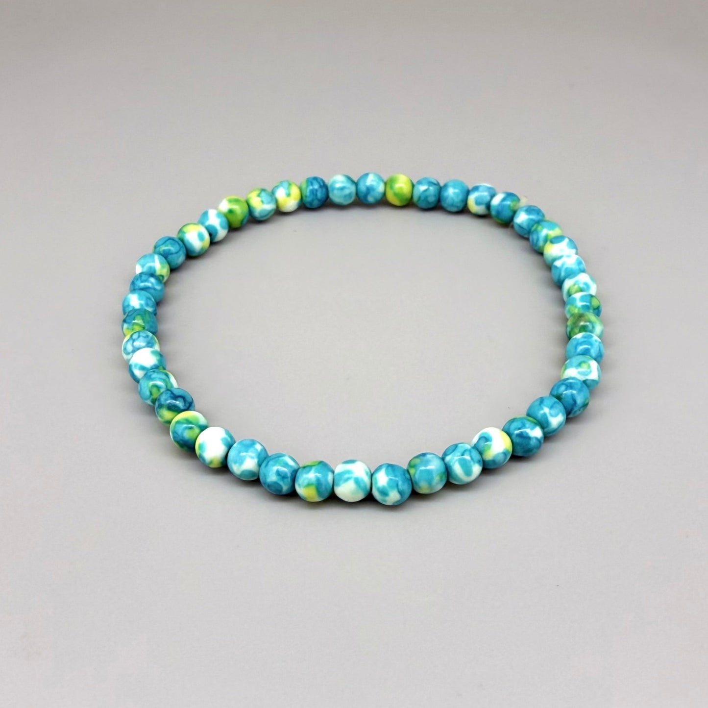 Jade beaded bracelet, 18cm, gemstone beads in turquoise, yellow, and white tones on elastic stretch band.
