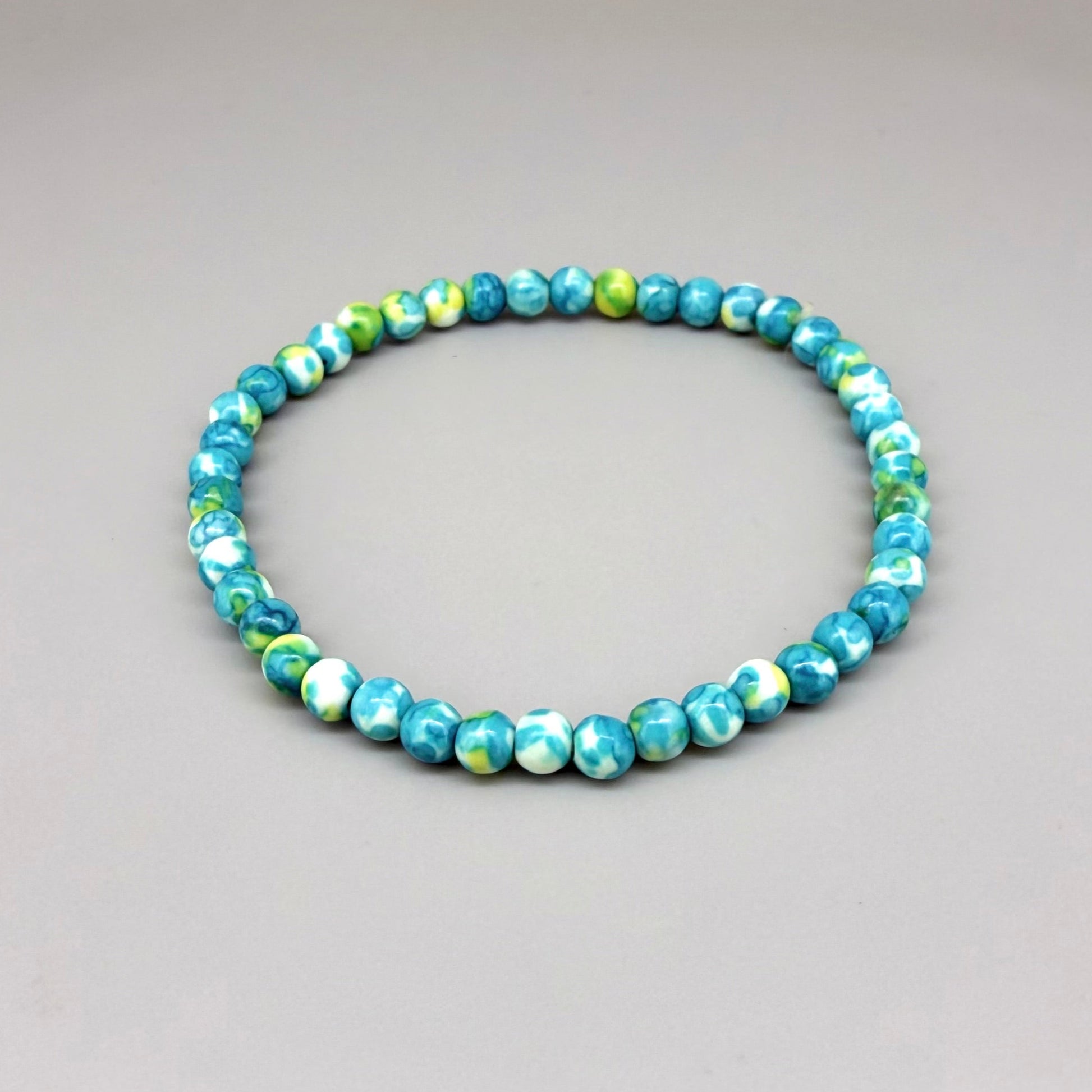 Jade beaded bracelet, 18cm, gemstone beads in turquoise, yellow, and white tones on elastic stretch band.