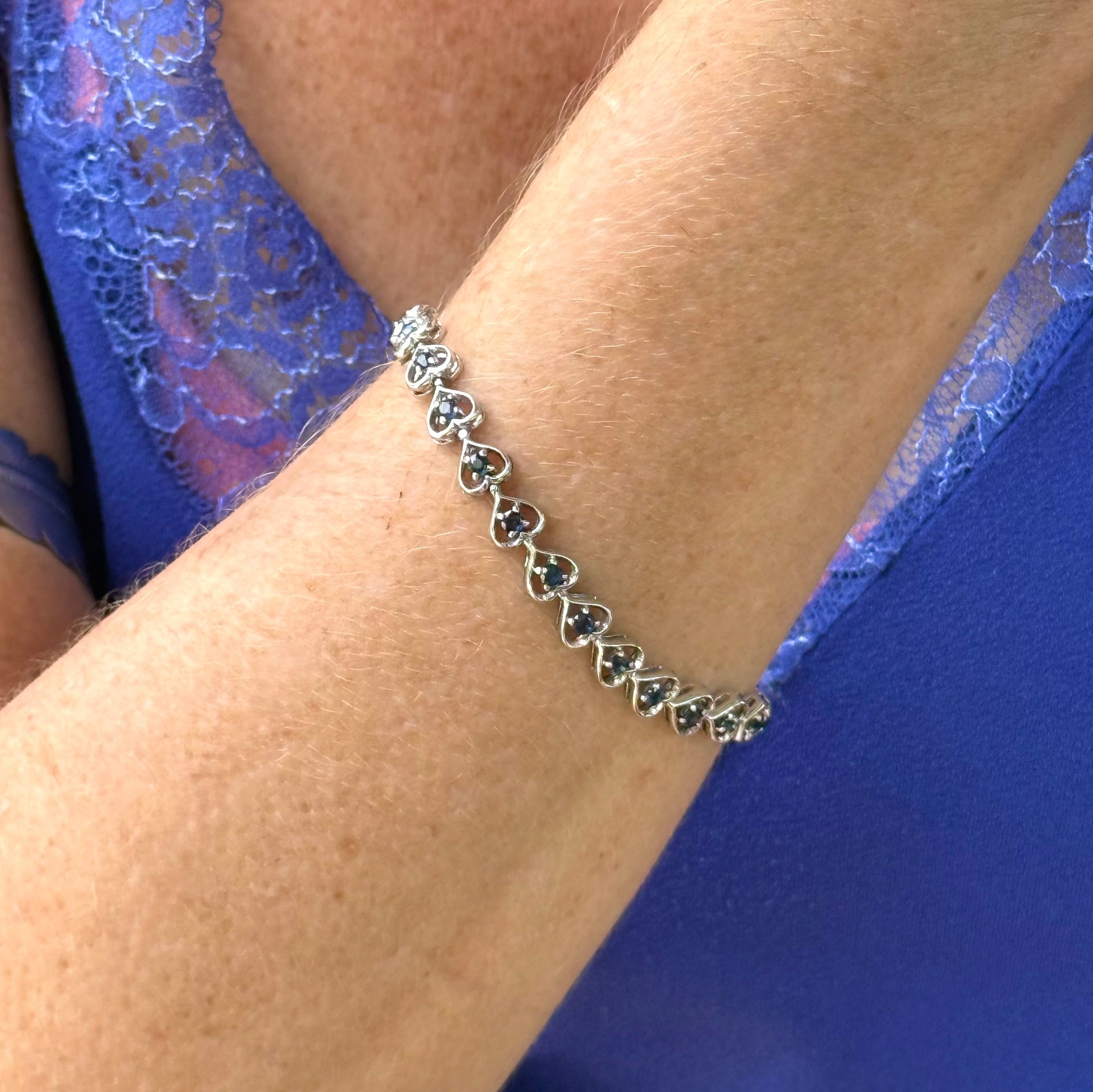 Sapphire bracelet in sterling silver with white gold plating, elegant design worn on arm