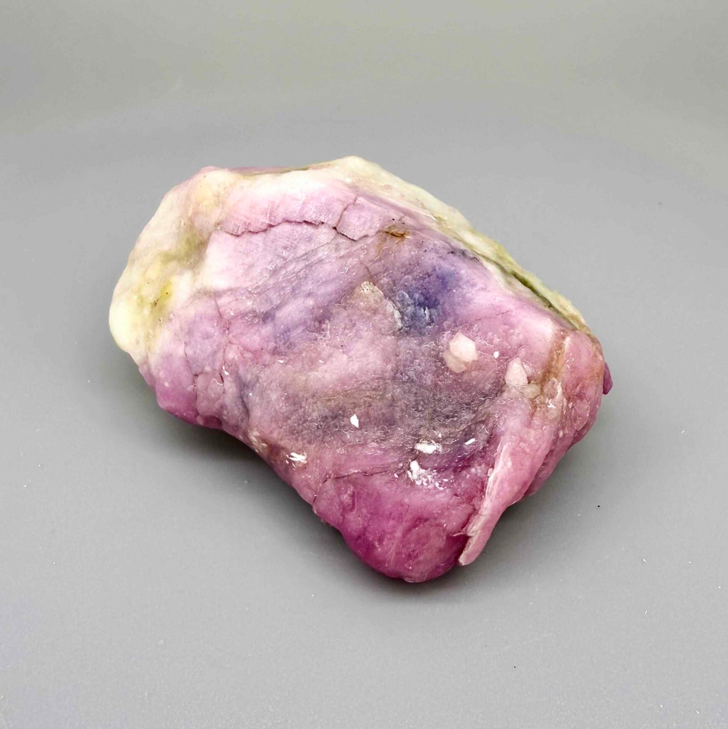 Natural ruby in creamy-white matrix, pink to purplish-pink rough corundum partially encased in host rock.