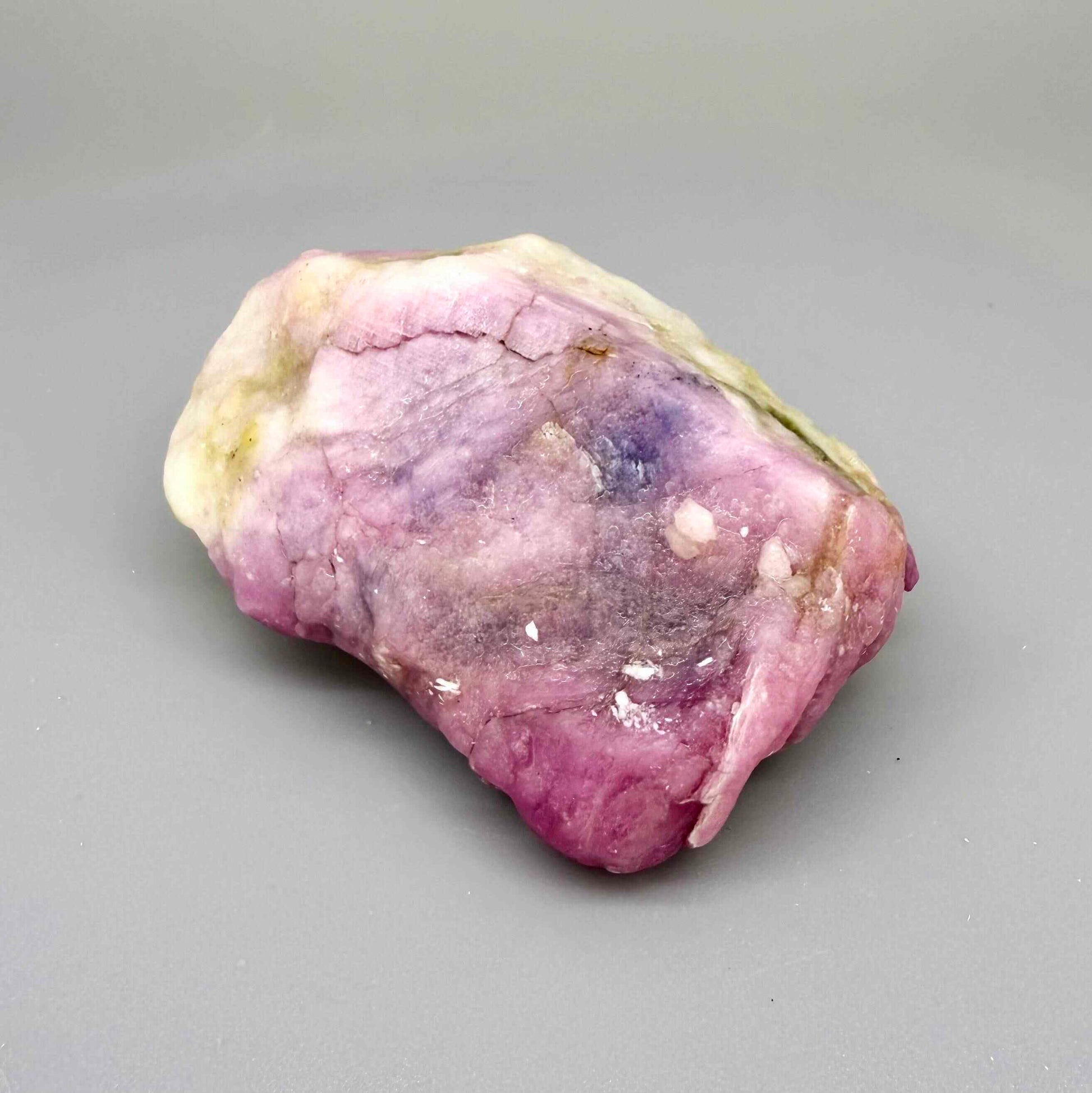 Natural ruby in creamy-white matrix, pink to purplish-pink rough corundum partially encased in host rock.