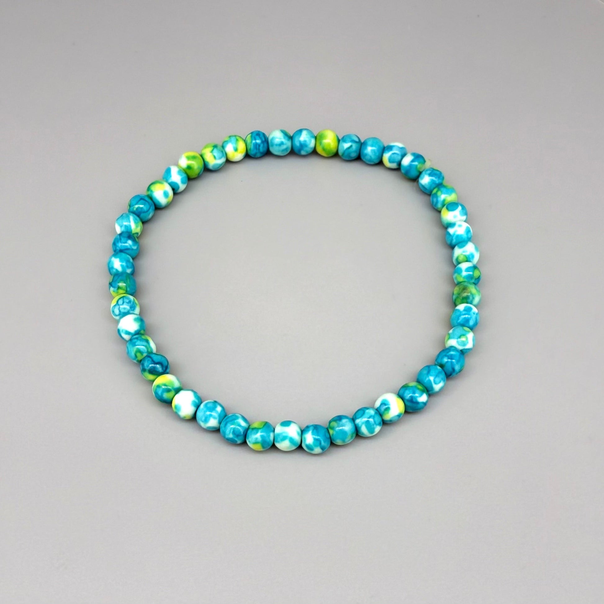 Jade beaded bracelet, 18cm, gemstone beads in turquoise, yellow, and white tones on elastic stretch band.