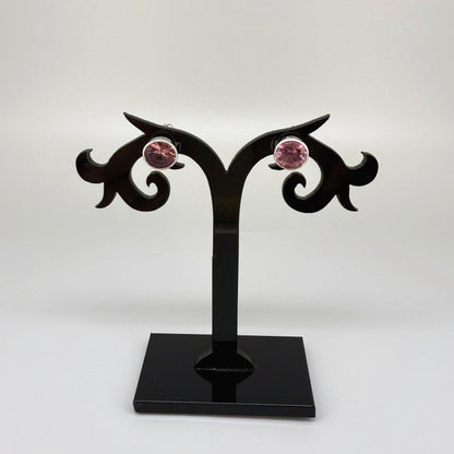 White gold plated sterling silver stud earrings featuring round-cut rhodolite garnets in a classic setting.